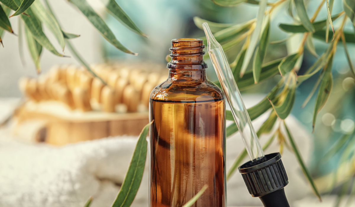 essential oil dropper with palm trees in background